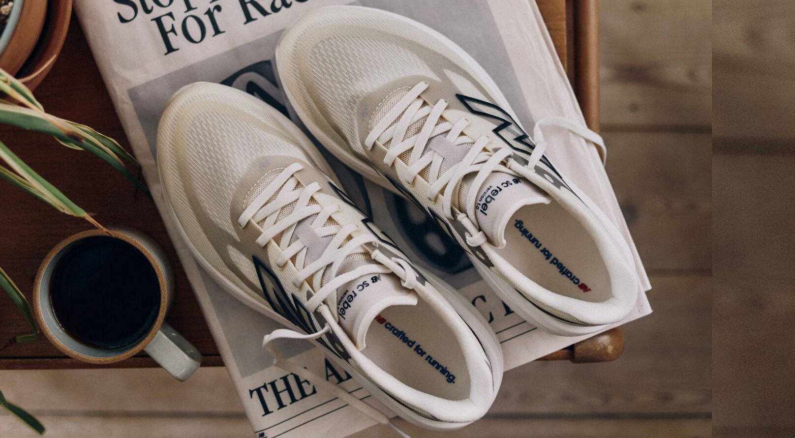 Overhead shot of New Balance running shoes placed on a newspaper.